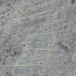 Rock faces have these characteristic scratches from gravel and rock that has been dragged across in the ice.